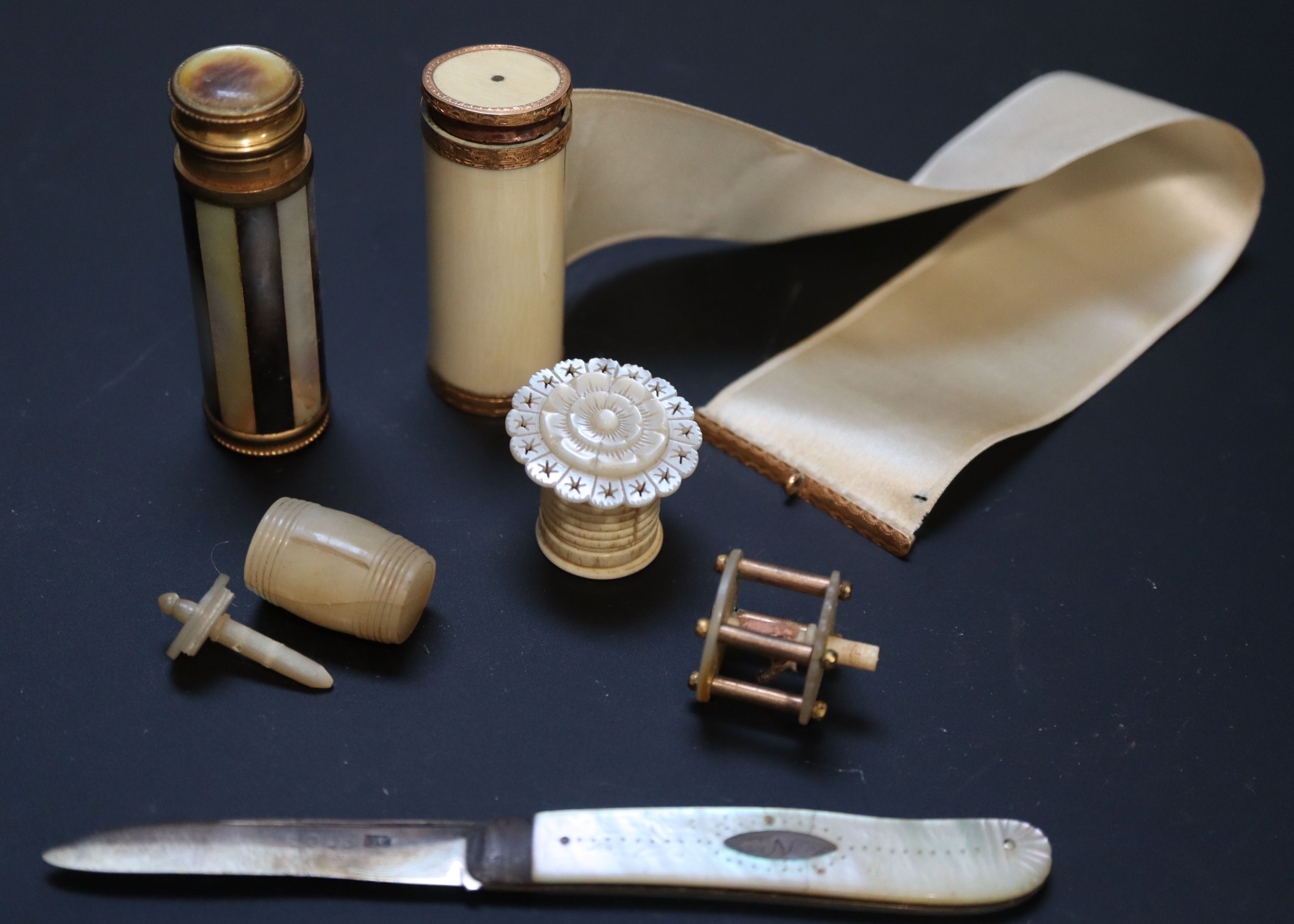 Four 19th century Palais Royale mother of pearl and ivory tape measures and two other accessories